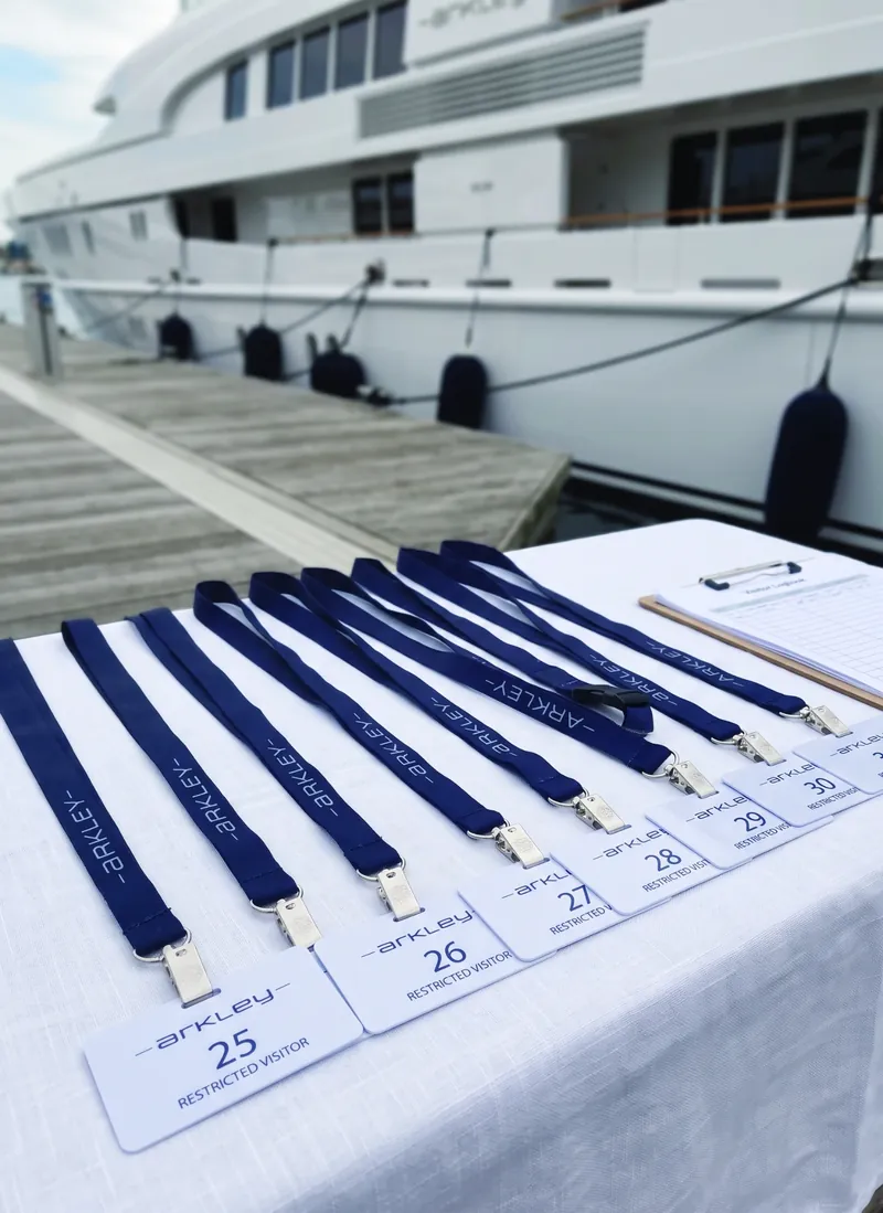 Branded visitor passes and lanyards laid out at the dock